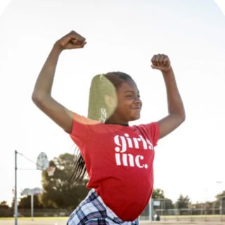 Young girl flexing her bicep muscles